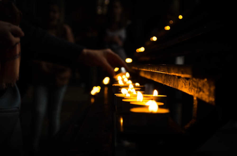 Candles Being Lit Inside a Cathedral, Illustrating the Somberness of Christine King Farris’s Passing